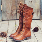 Tall lace-up riding boots with side buckle and lugged soles