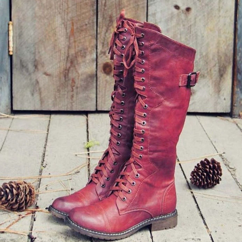 Tall lace-up riding boots with side buckle and lugged soles