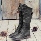 Tall lace-up riding boots with side buckle and lugged soles