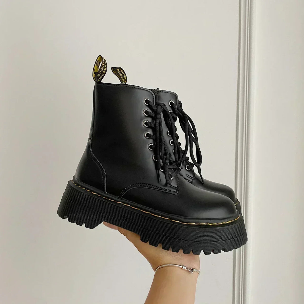 Black women's lace-up combat boots with chunky platform soles