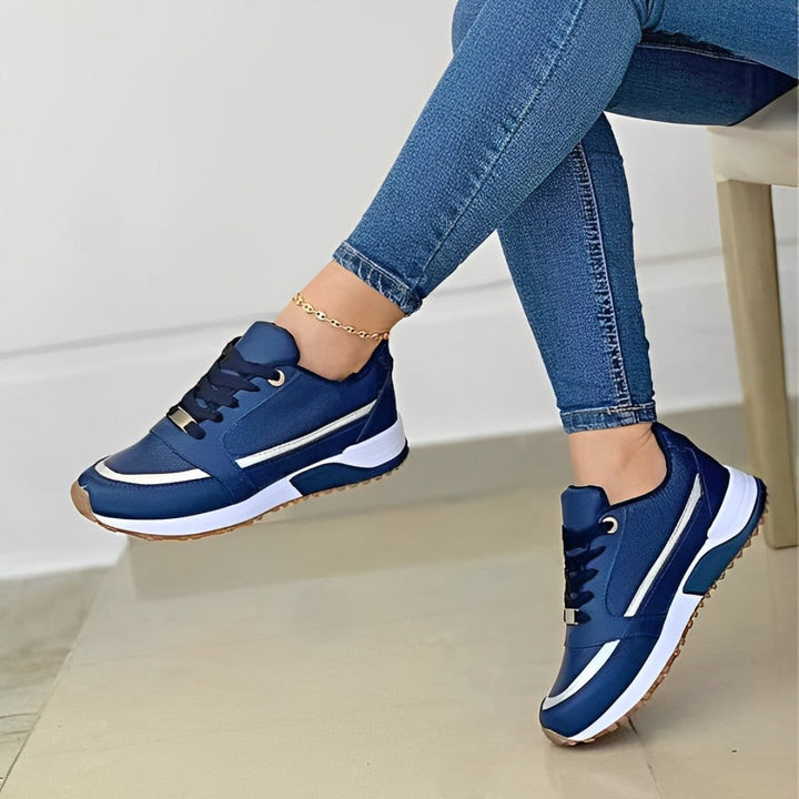 Women's lace-up running sneakers with layered panels and textured sole