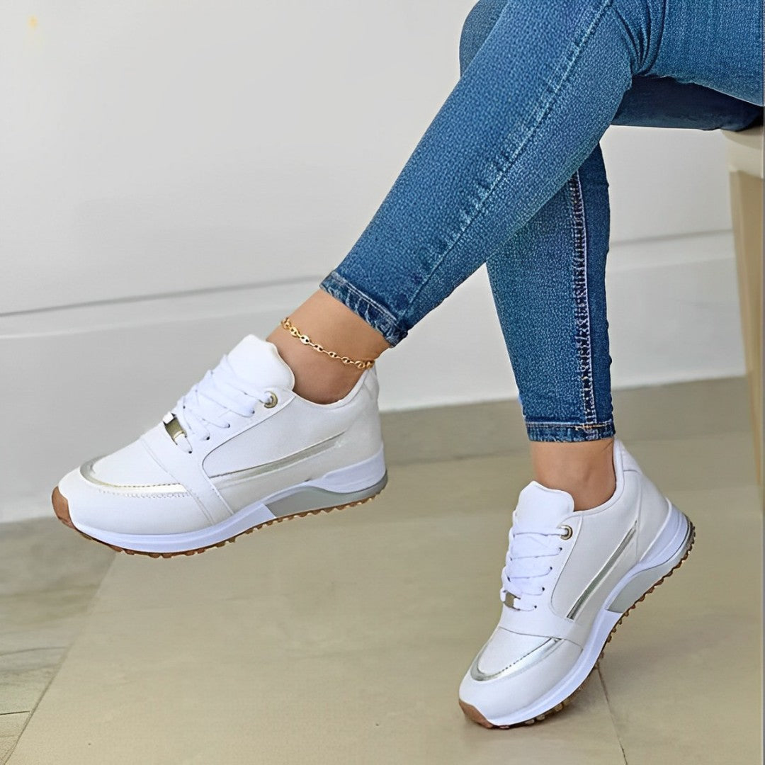 Women's lace-up running sneakers with layered panels and textured sole