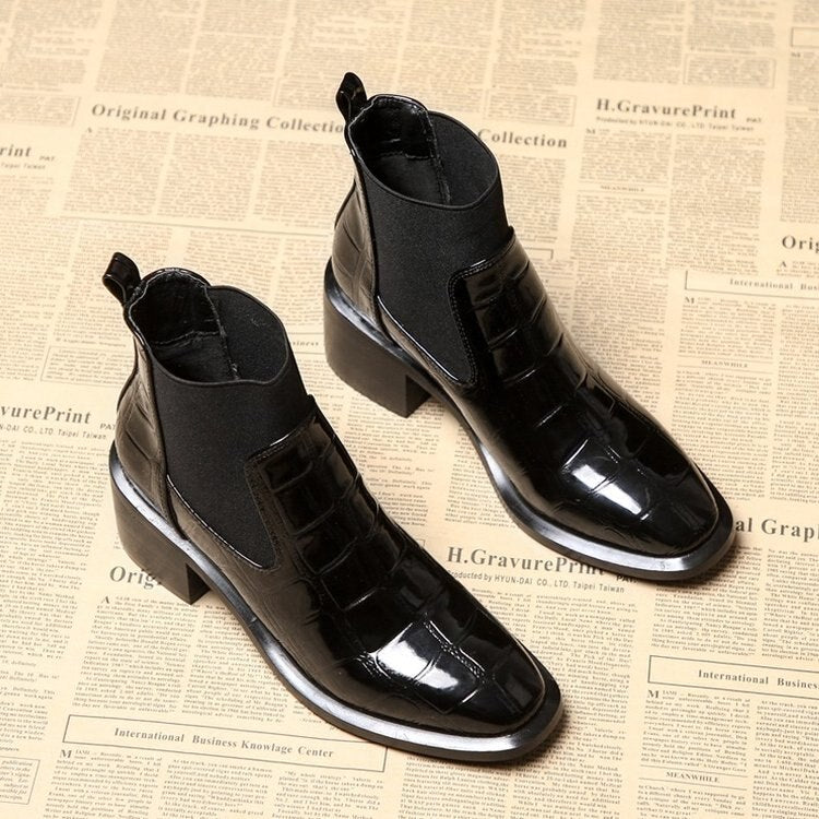 Women's black Chelsea ankle boots with glossy crocodile-effect panels and block heels