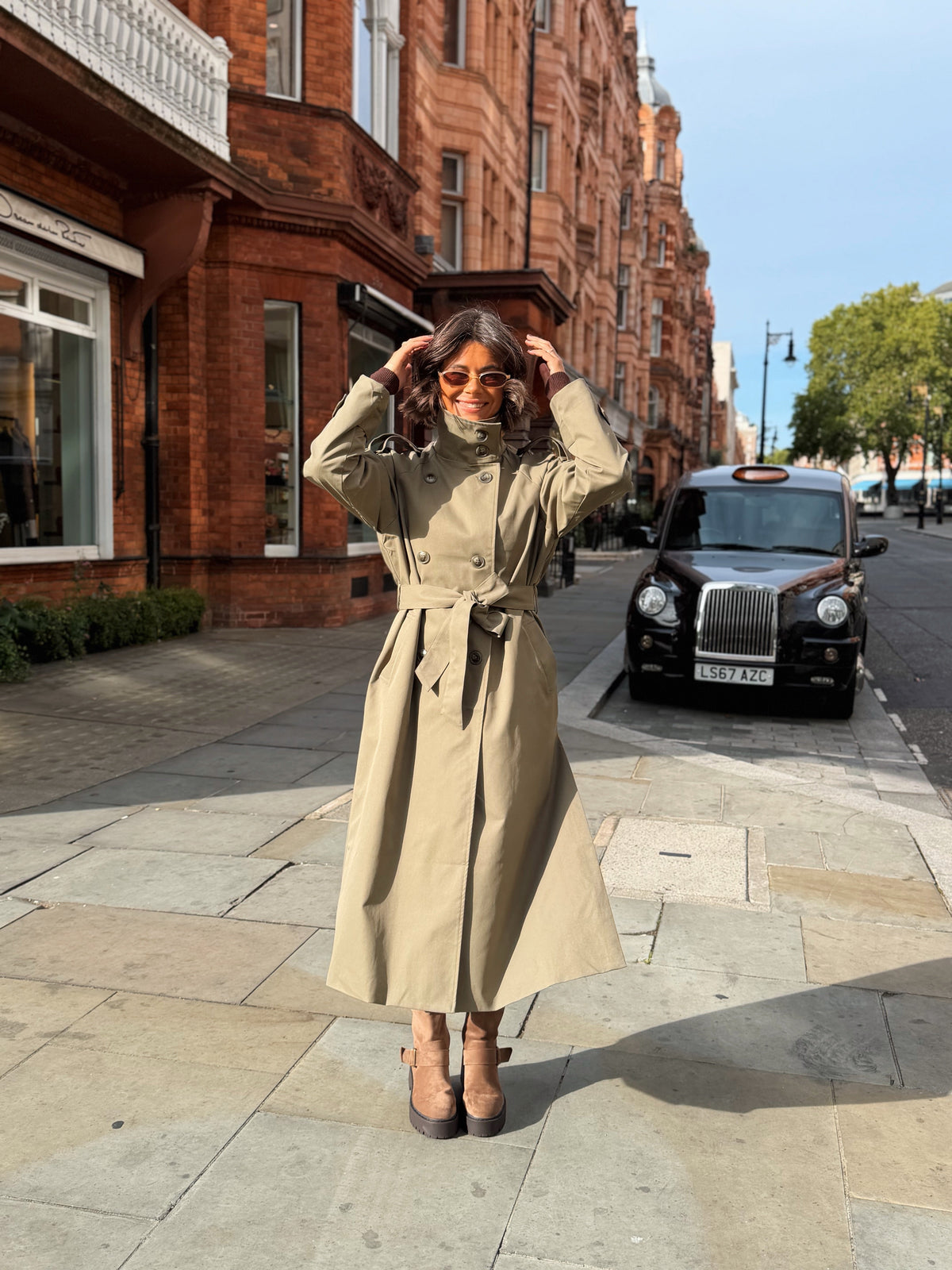 Women's beige belted trench coat with cape overlay and long sleeves