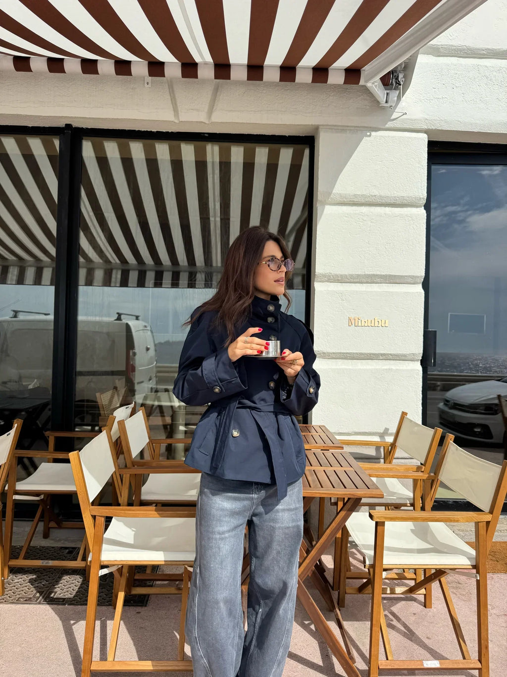 Women's navy short belted jacket with high collar, buttons and flap pockets