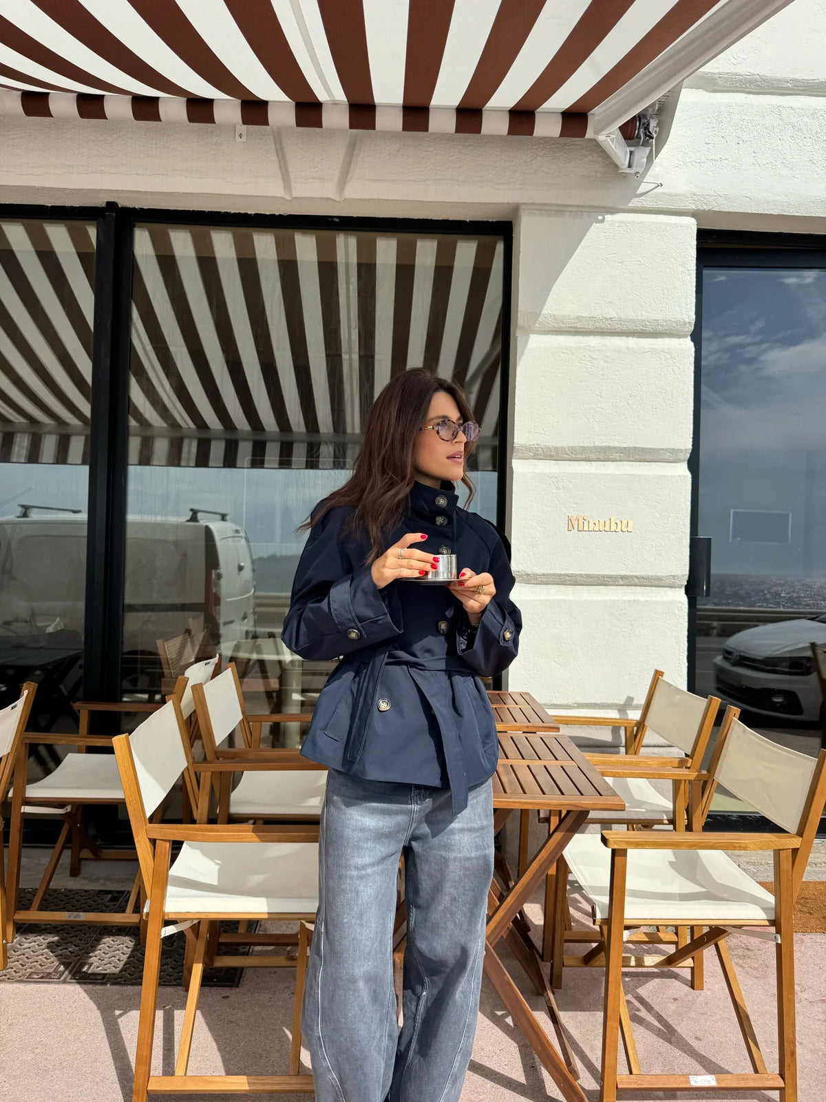 Women's navy short belted jacket with high collar, buttons and flap pockets