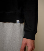 Men's black raglan crew neck sweatshirt with ribbed hem