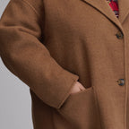 Women's camel long coat with notched lapels, front buttons and patch pockets