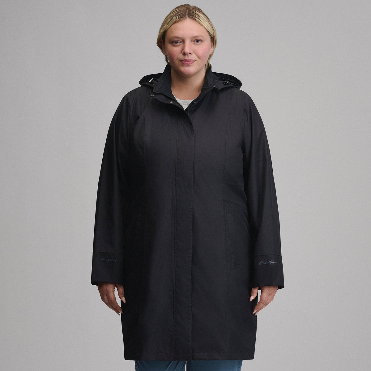 Women's hooded waterproof trench coat with long sleeves and front pockets