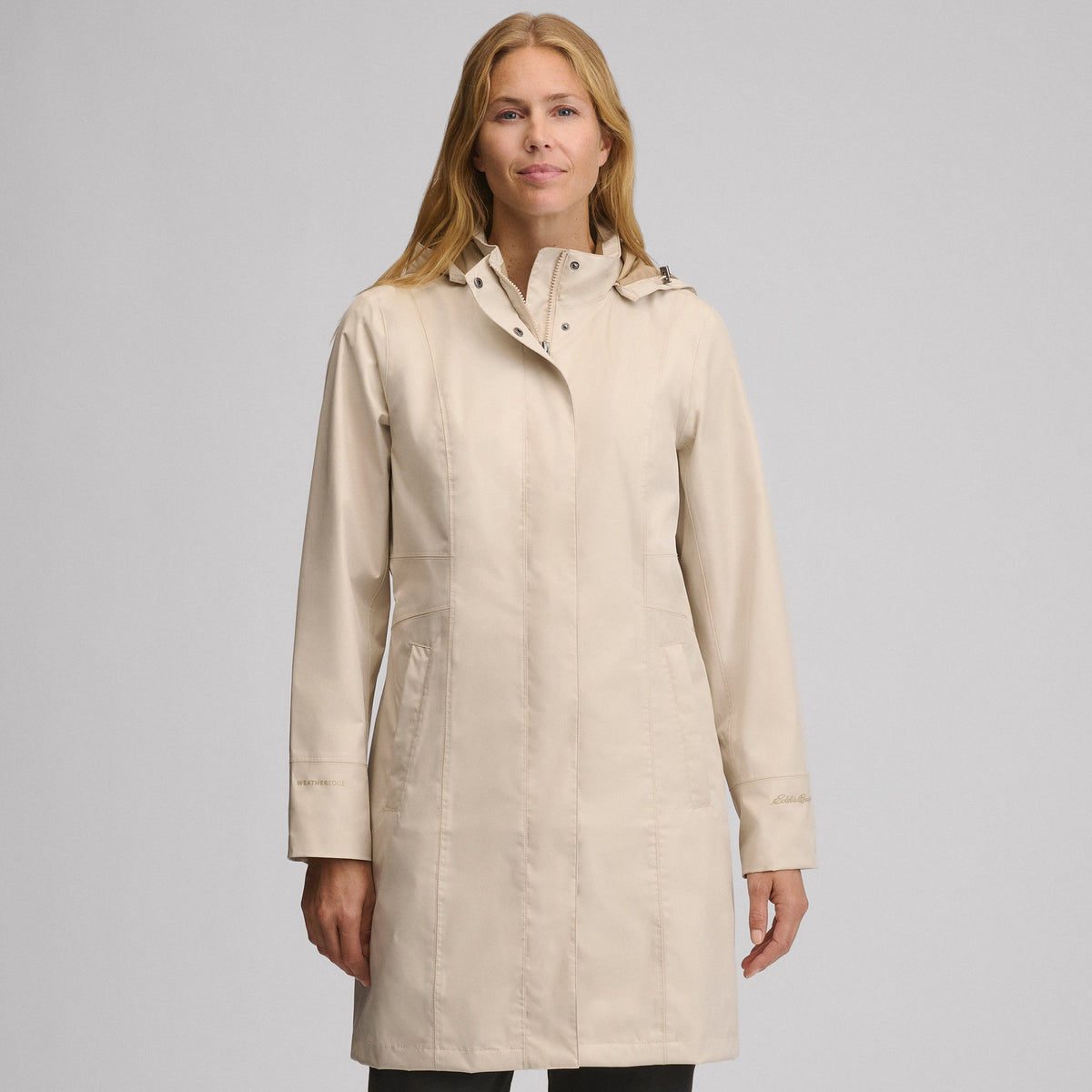 Women's hooded waterproof trench coat with long sleeves and front pockets