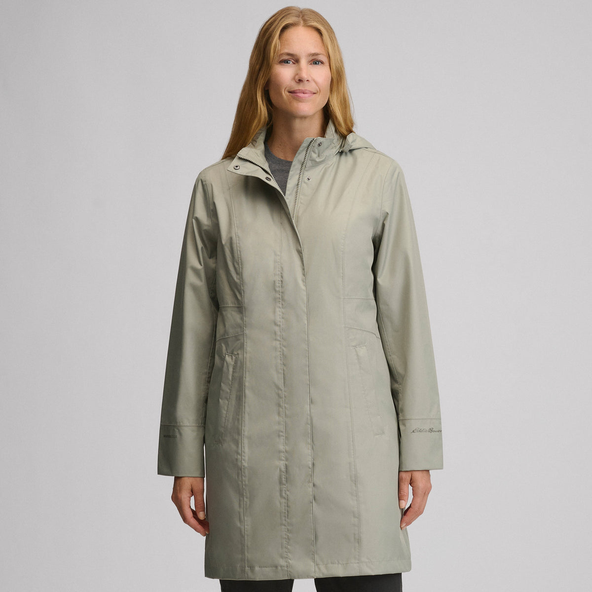 Women's hooded waterproof trench coat with long sleeves and front pockets