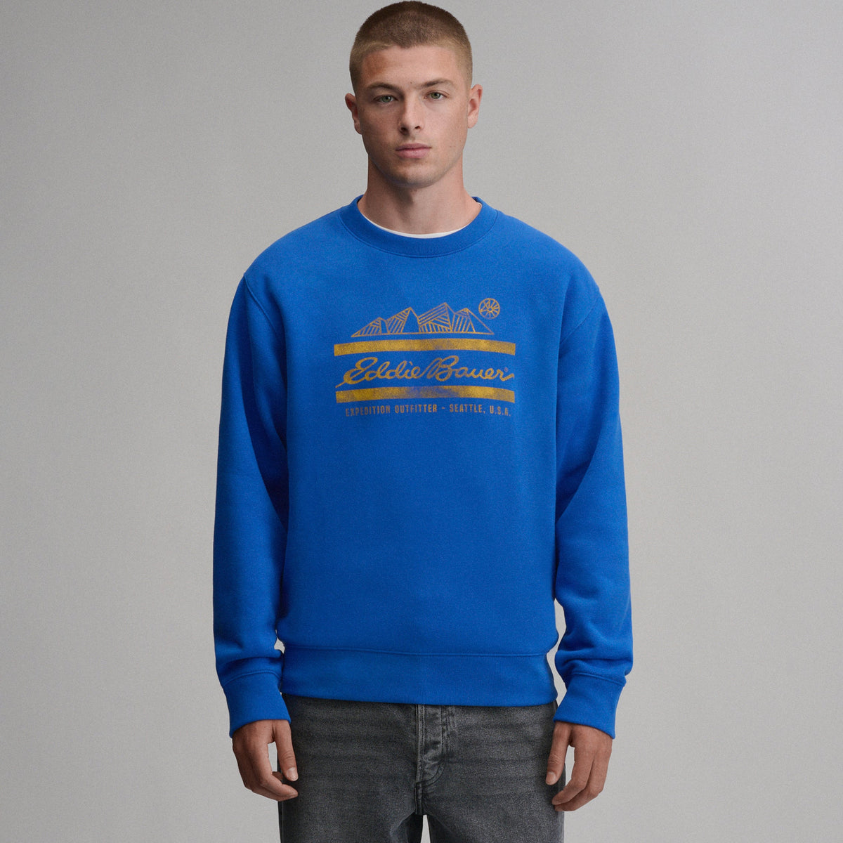 Men's blue crew neck sweatshirt with mountain and script chest graphic