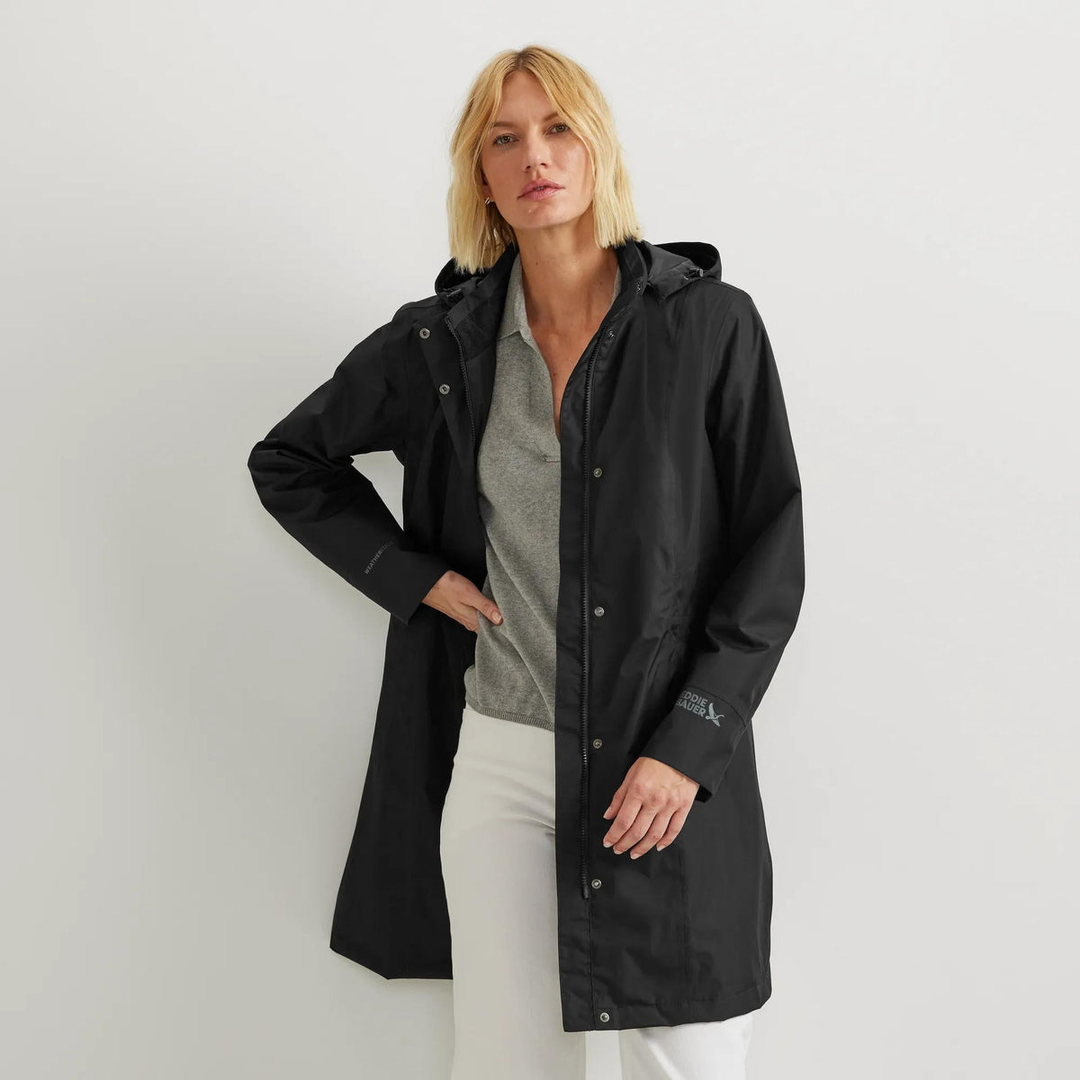 Women's hooded waterproof trench coat with long sleeves and front pockets