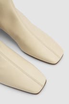 Women's off white knee-high boots with square toe and low block heel