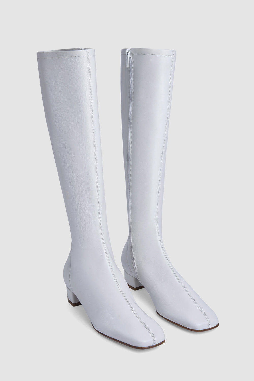 White women's knee-high boots with square toes and low heels