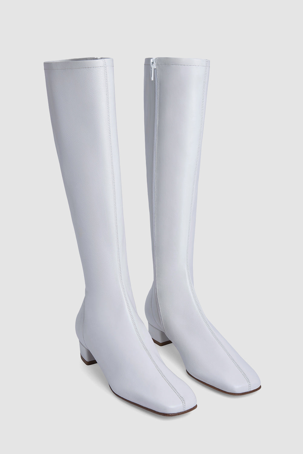 White women's knee-high boots with square toes and low heels