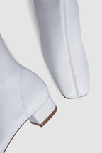 White women's knee-high boots with square toes and low heels