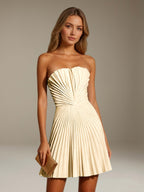 Women's strapless pleated A-line mini dress with a fitted bodice and flared skirt