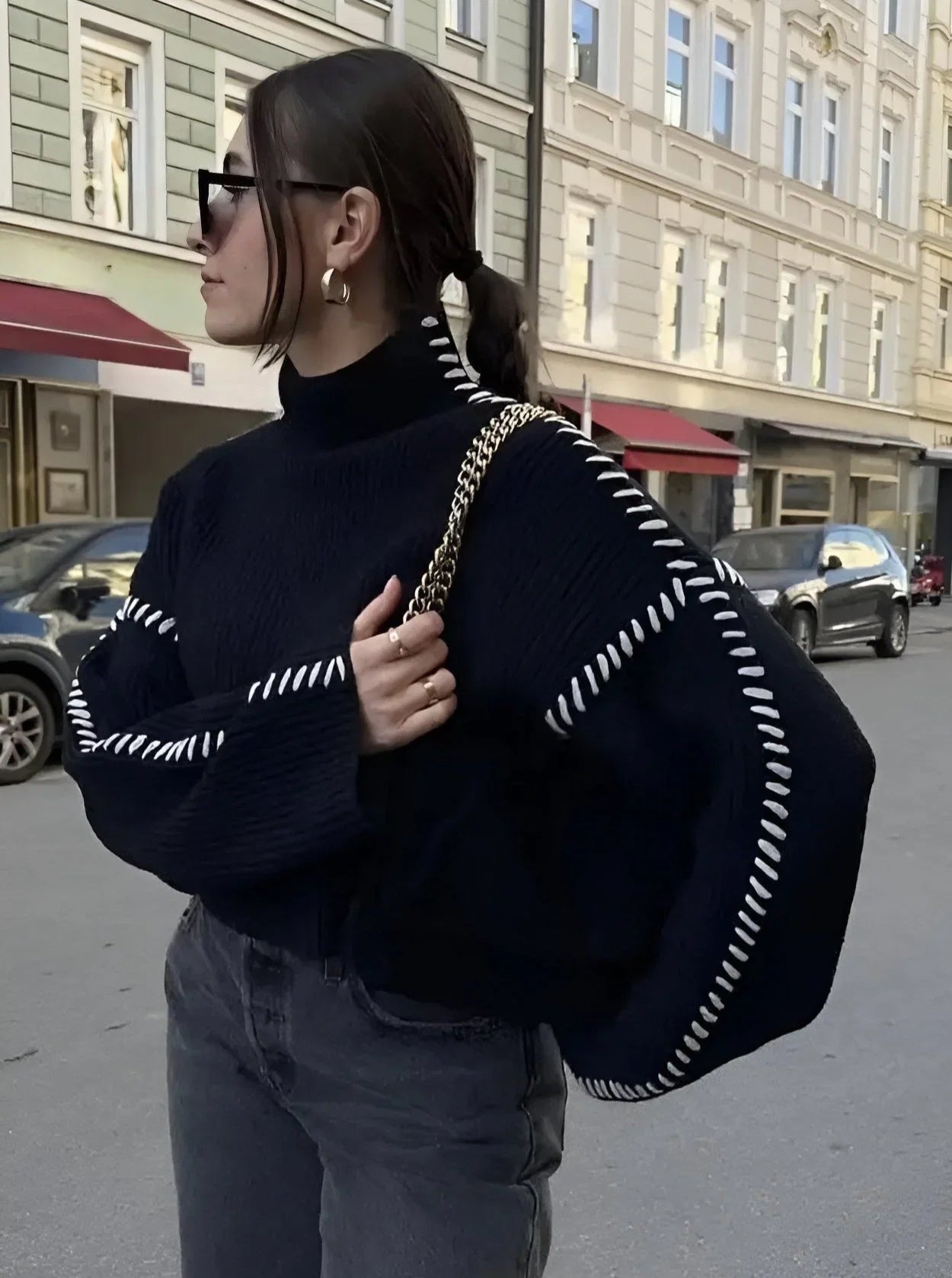 Women's knit sweater with contrast stitch trim and long sleeves