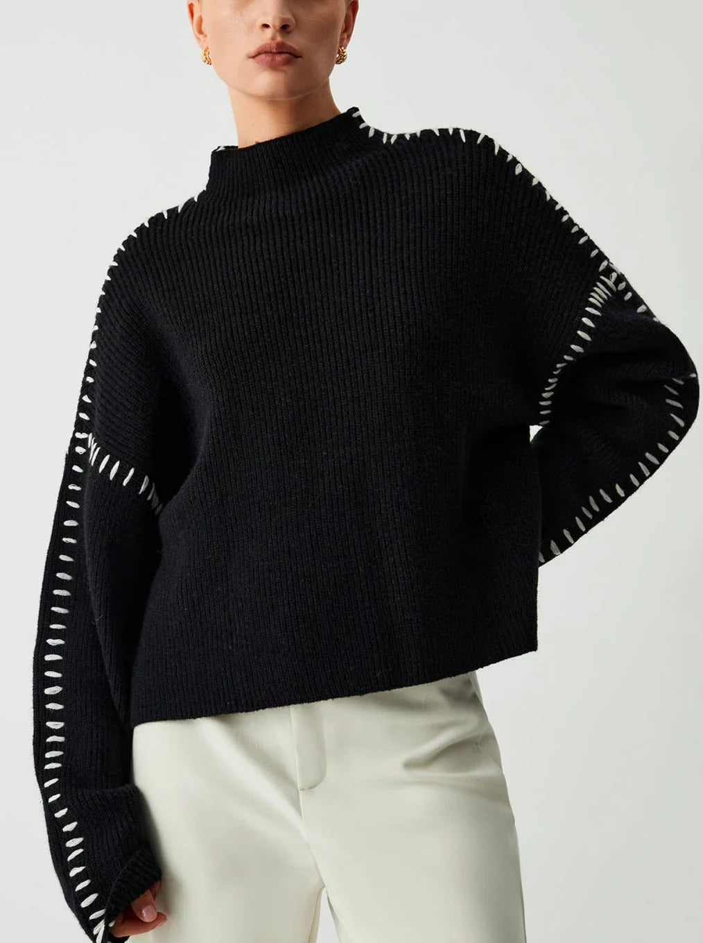 Women's knit sweater with contrast stitch trim and long sleeves