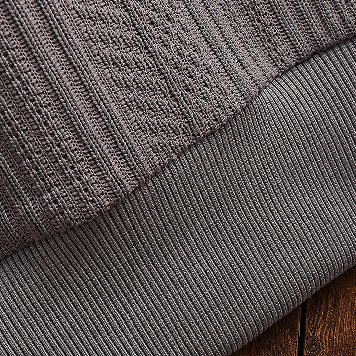 Men's textured polo sweater with collared neckline, buttons and long sleeves