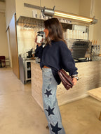 Women's light blue wide leg jeans with studded star leg details
