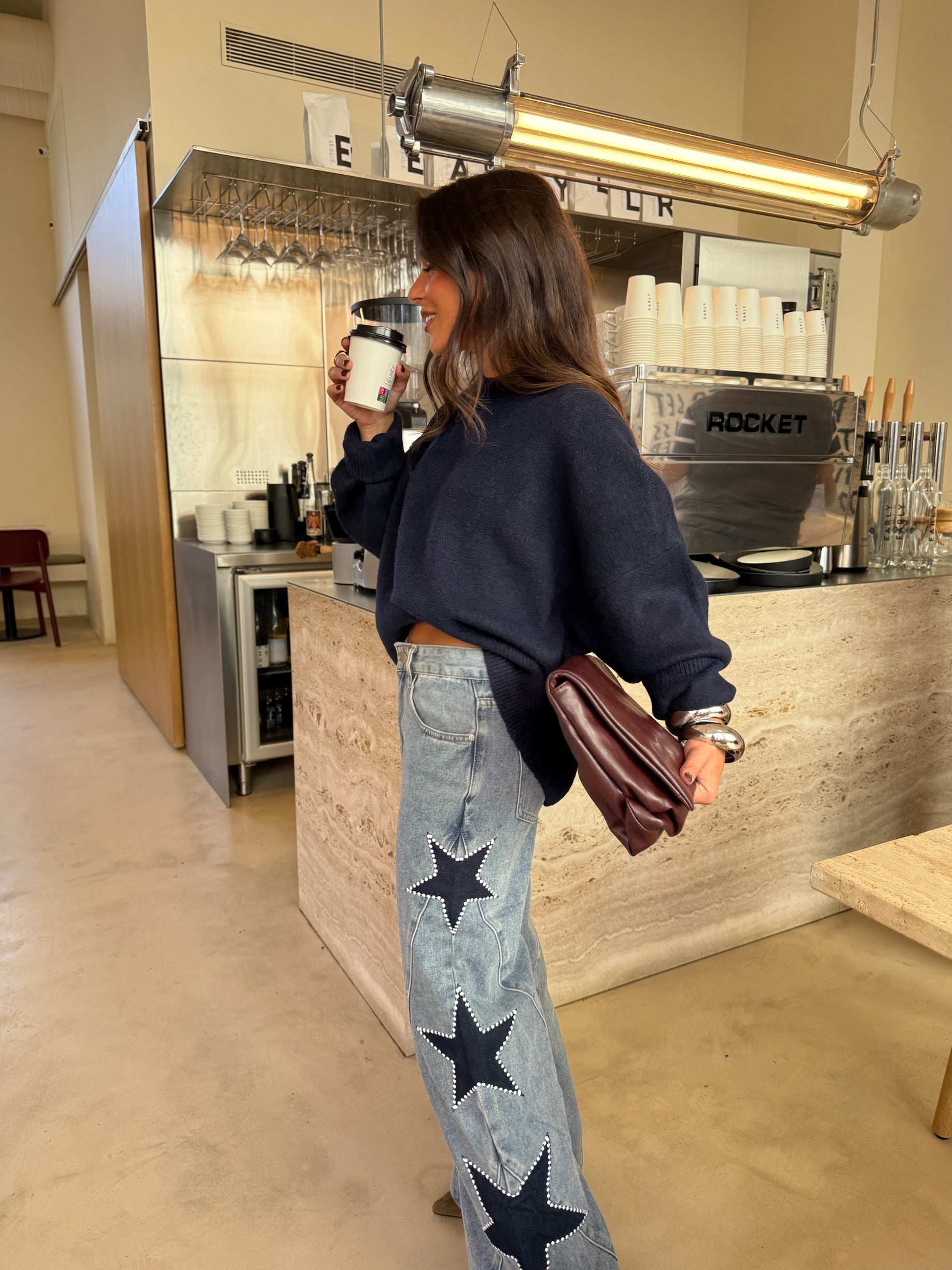 Women's light blue wide leg jeans with studded star leg details