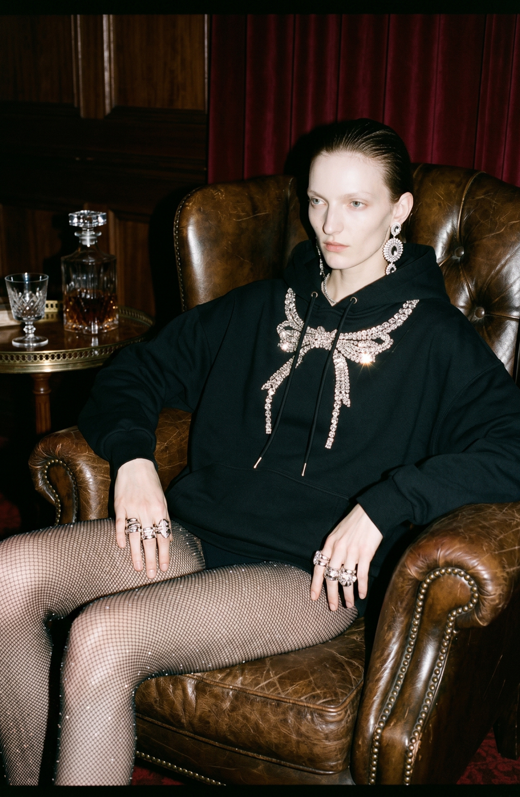 Black embellished hoodie with drawstring hood and wing motif
