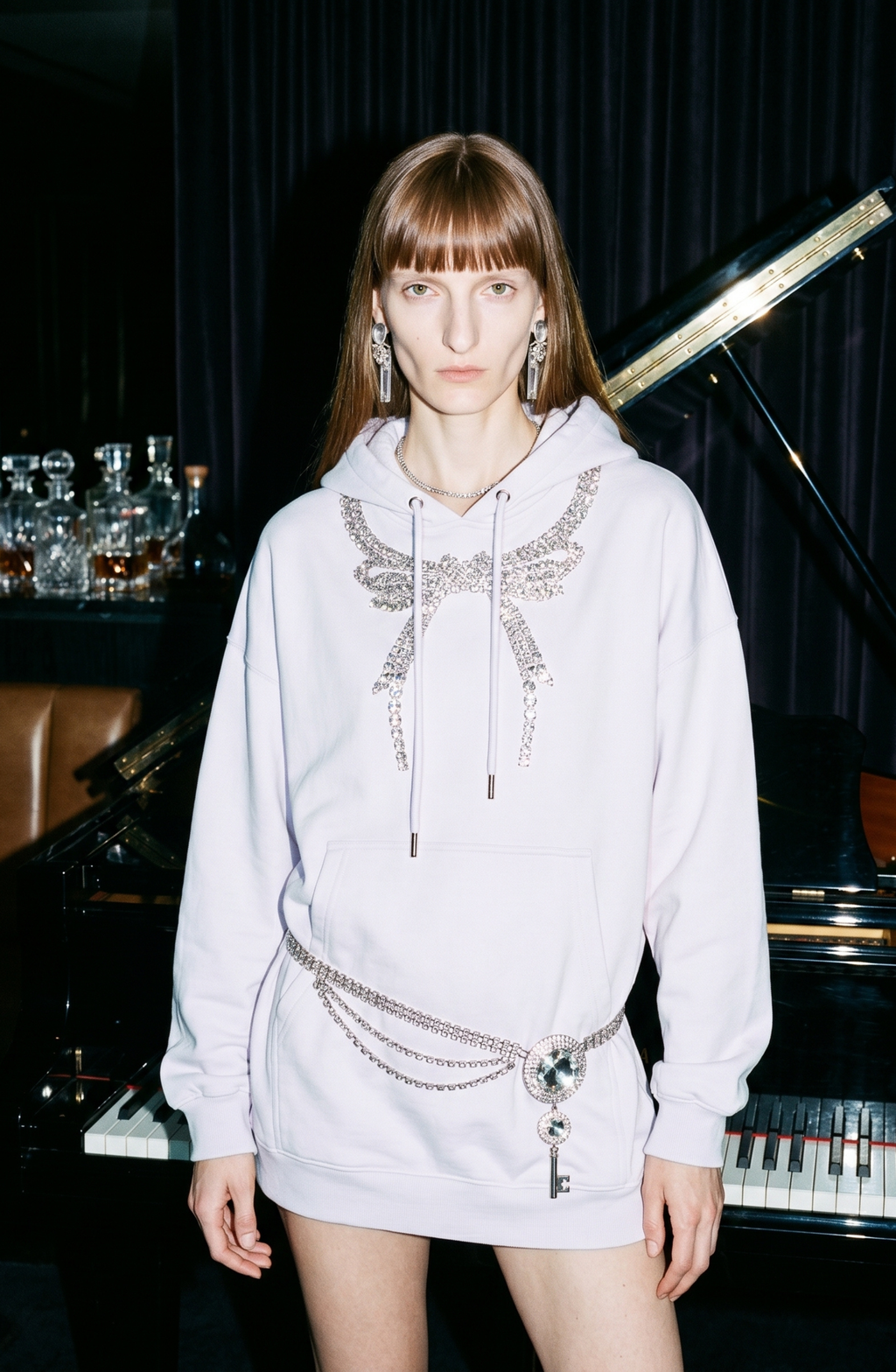 Black embellished hoodie with drawstring hood and wing motif