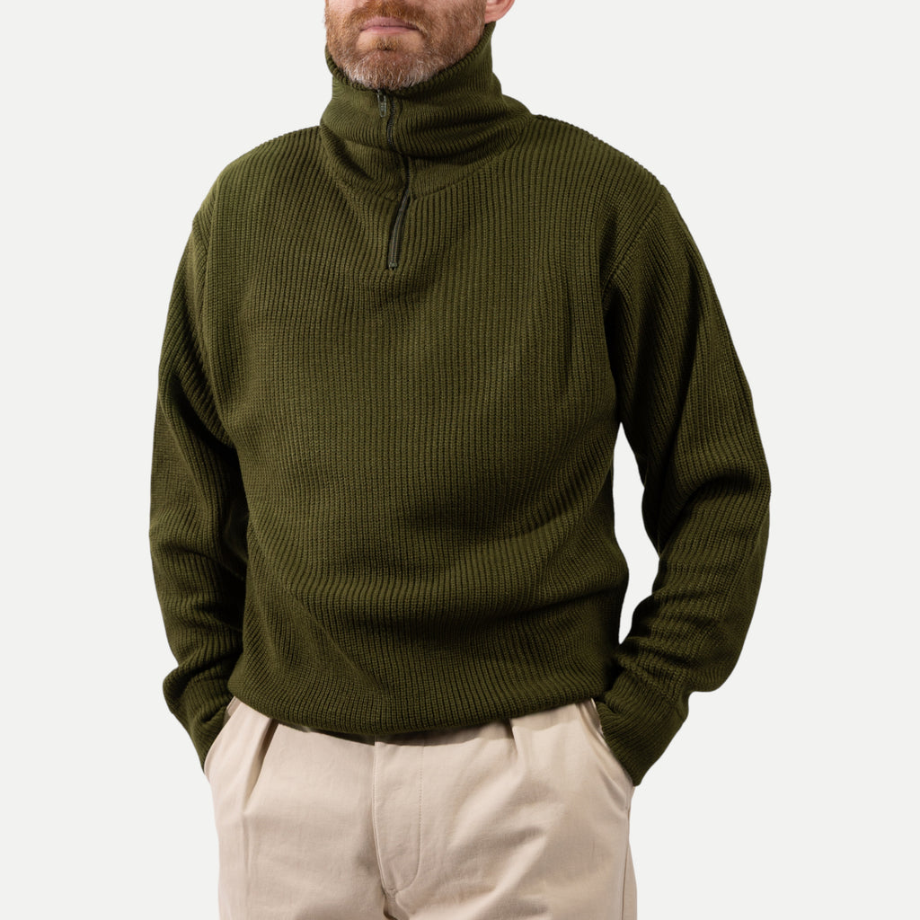 Men's olive green ribbed half-zip jumper with a high collar and long sleeves