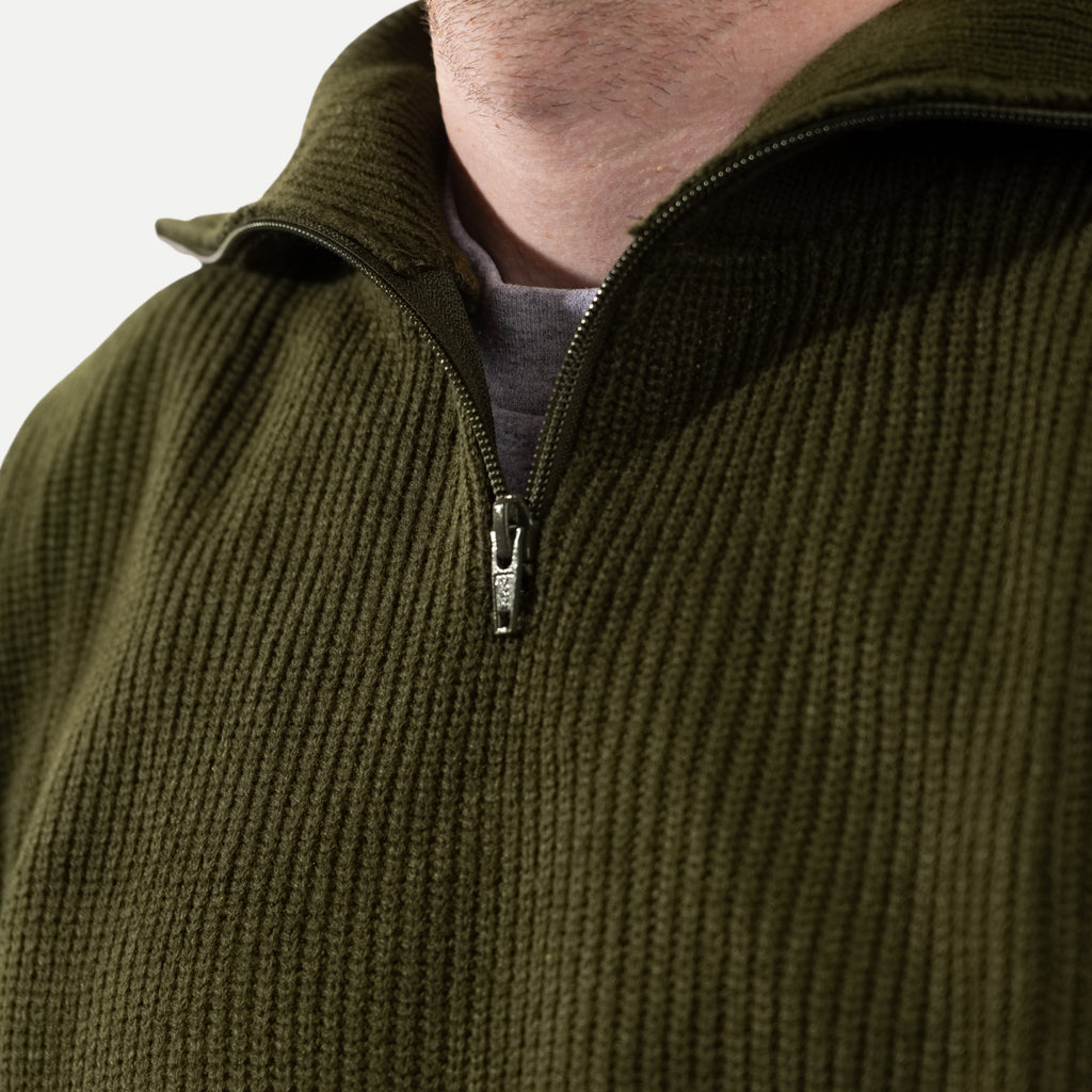 Men's olive green ribbed half-zip jumper with a high collar and long sleeves