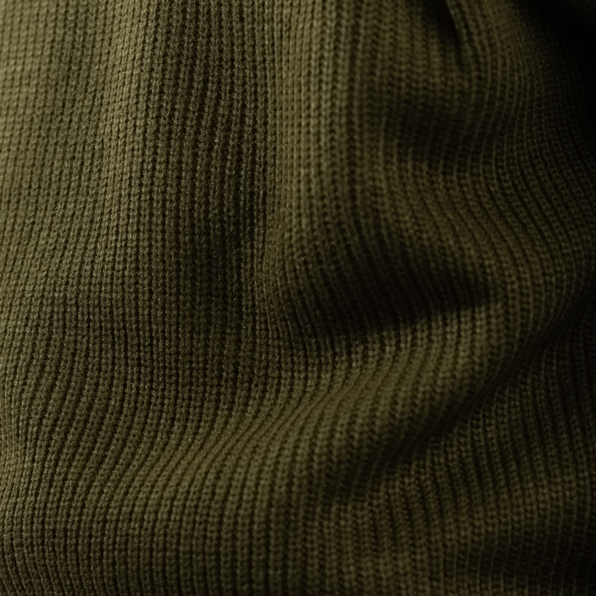 Men's olive green ribbed half-zip jumper with a high collar and long sleeves