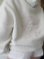 Women's light grey oversized hoodie with pink bow embroidery and floral-lined hood