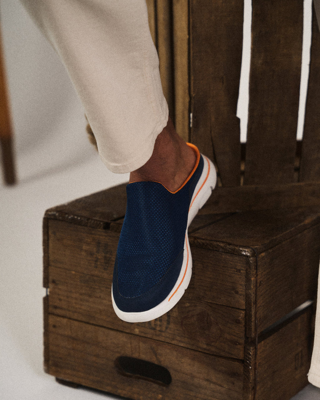 Unisex slip-on sneaker slides with textured upper and white segmented sole