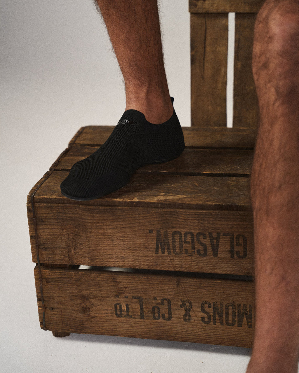 Knit barefoot-style slip-on shoes with textured panels and pull tabs