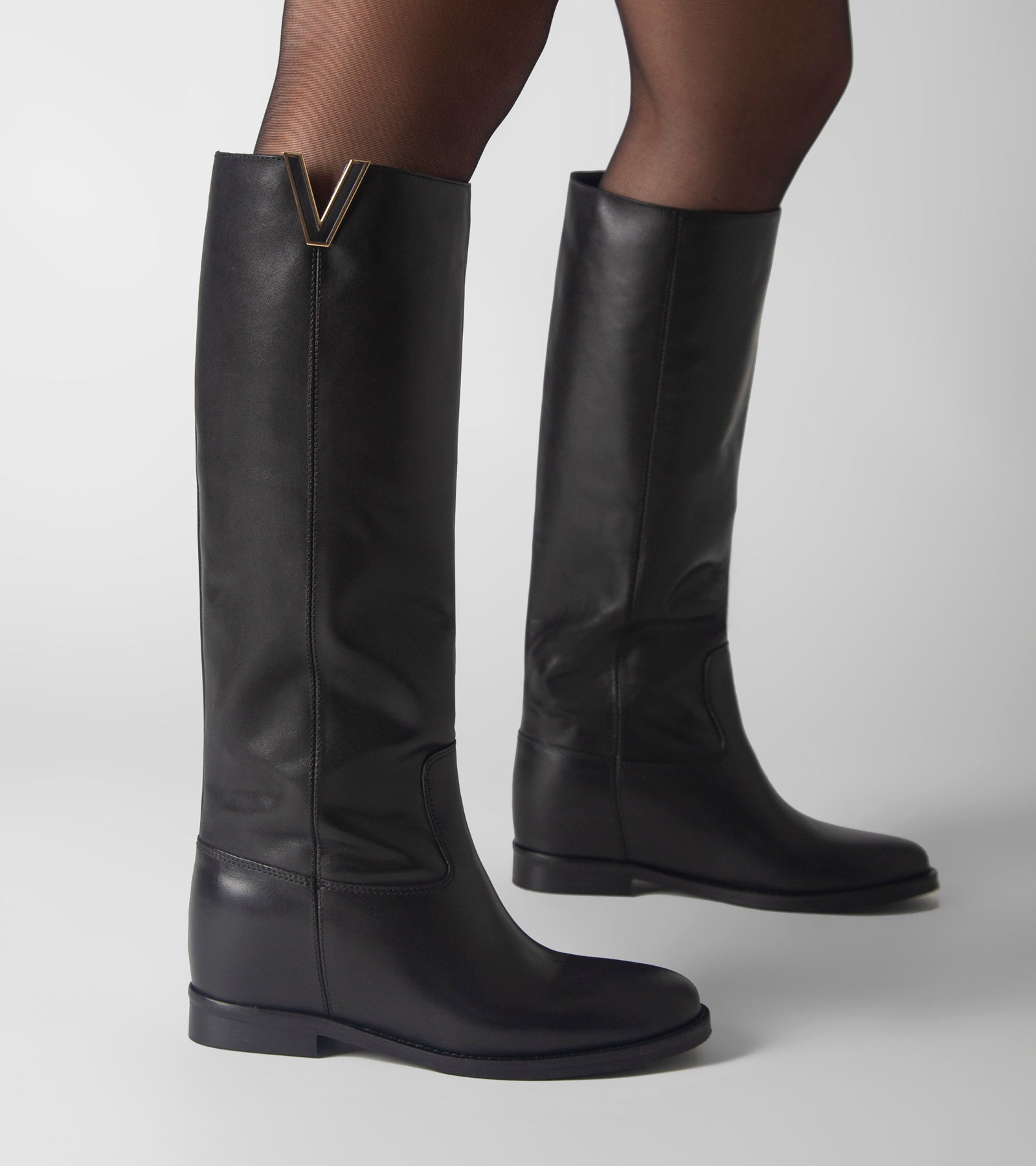 Women's black knee-high boots with V-cut topline