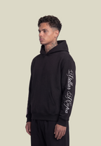 Black unisex pullover hoodie with sleeve lettering