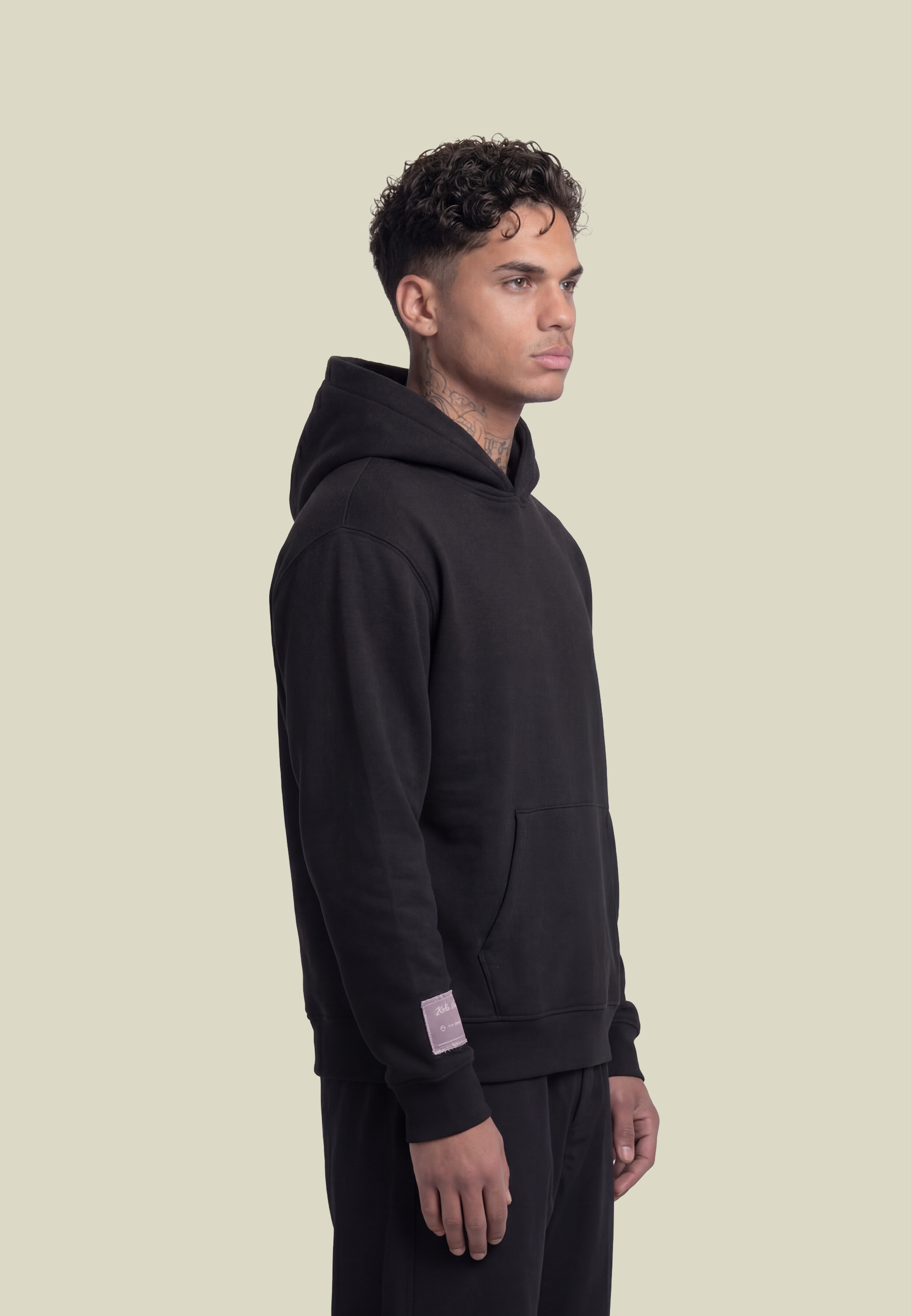 Black unisex pullover hoodie with sleeve lettering