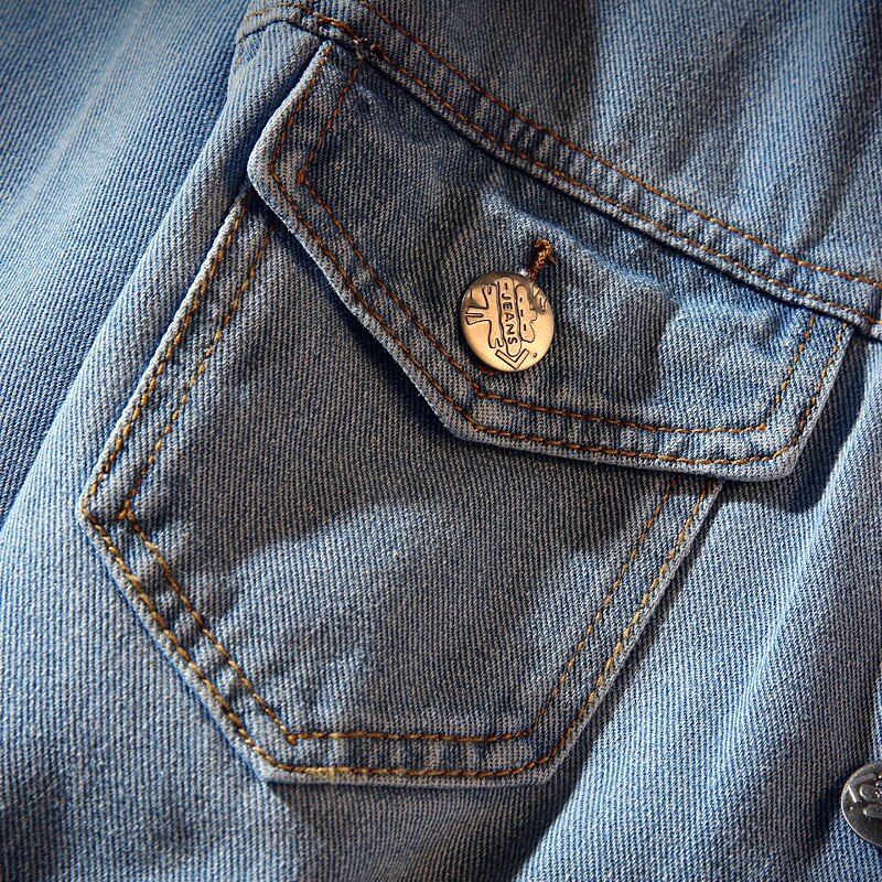Men's light blue denim jacket with button front and ribbed trims