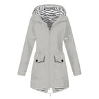 Women's hooded trench coat with long sleeves, zip front and flap pockets