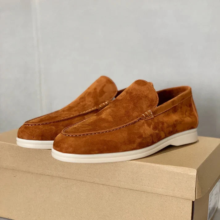 Men's slip-on loafers with textured uppers, moc toe stitching and white flat soles