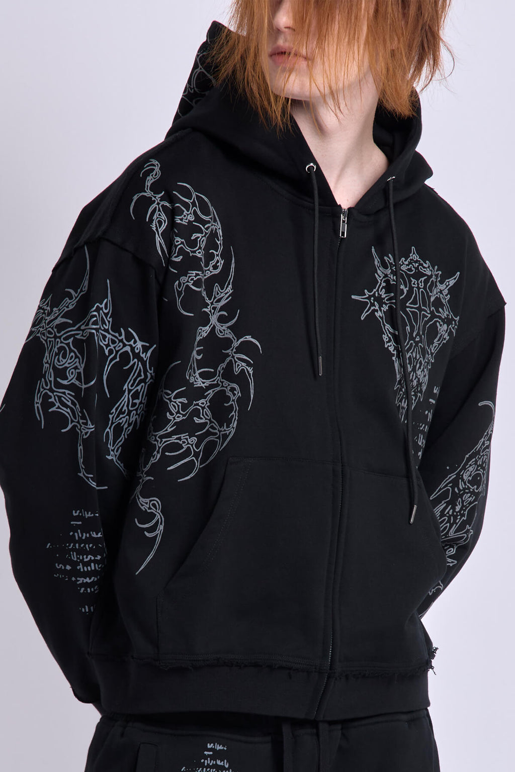 Black graphic zip hoodie with drawstring hood and long sleeves
