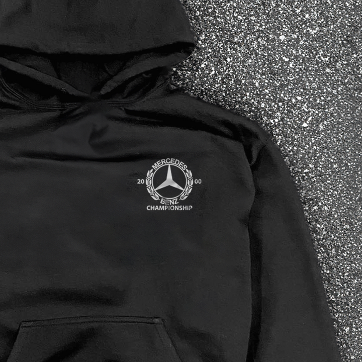 Black hooded hoodie with white Mercedes-Benz Championship chest logo and front kangaroo pocket