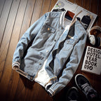 Men's light blue denim jacket with button front and ribbed trims