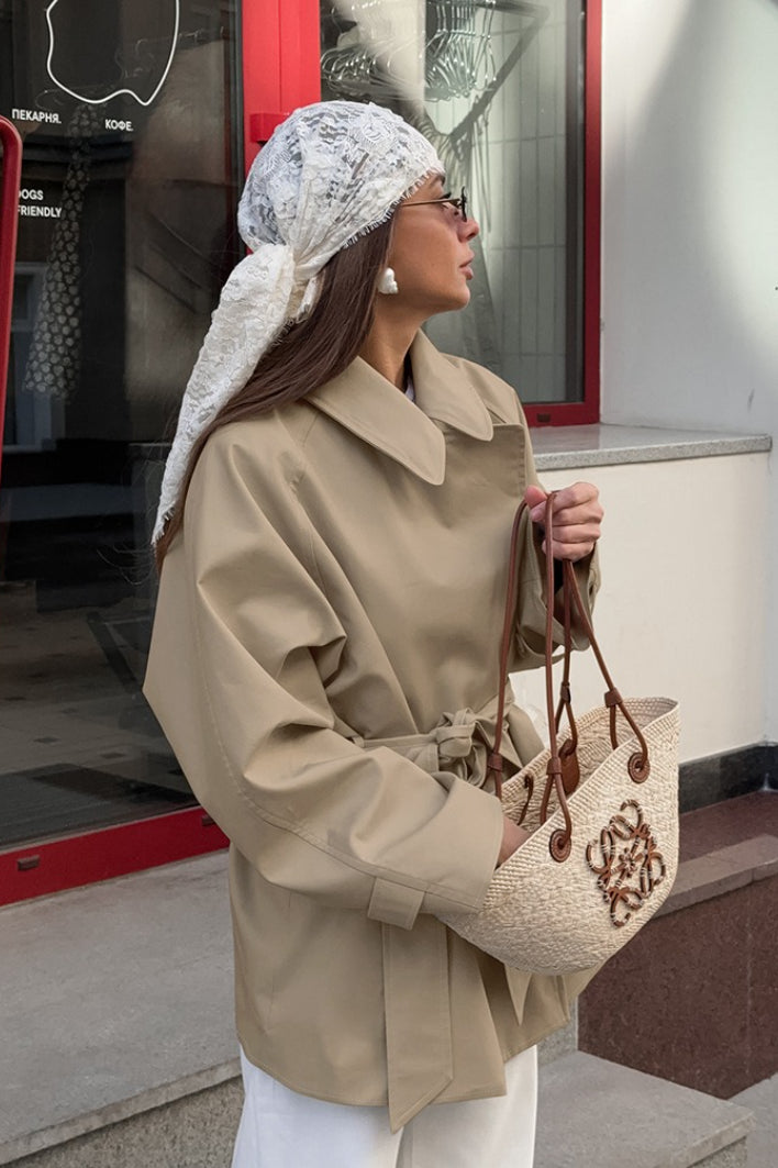Women's khaki double-breasted trench coat with rounded collar and tie belt