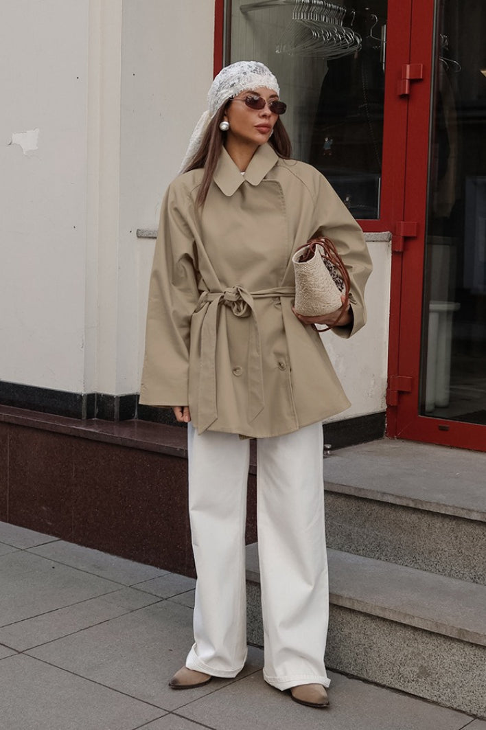 Women's khaki double-breasted trench coat with rounded collar and tie belt