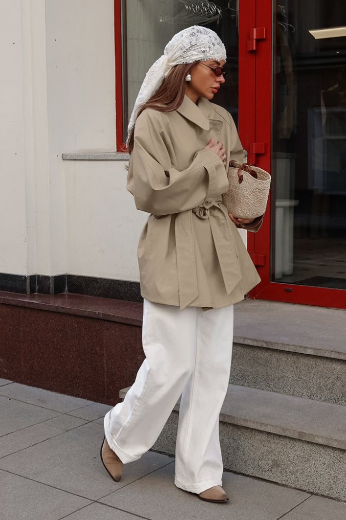 Women's khaki double-breasted trench coat with rounded collar and tie belt