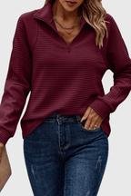 Women's ribbed quarter-zip sweater with long sleeves and raised collar