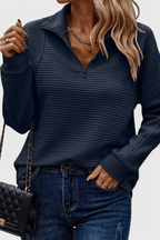 Women's ribbed quarter-zip sweater with long sleeves and raised collar
