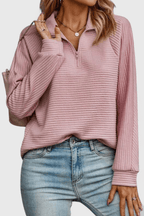 Women's ribbed quarter-zip sweater with long sleeves and raised collar